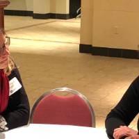 A student and an alumna discuss the students resume at the Cover Letter and Resume Roundtable Event